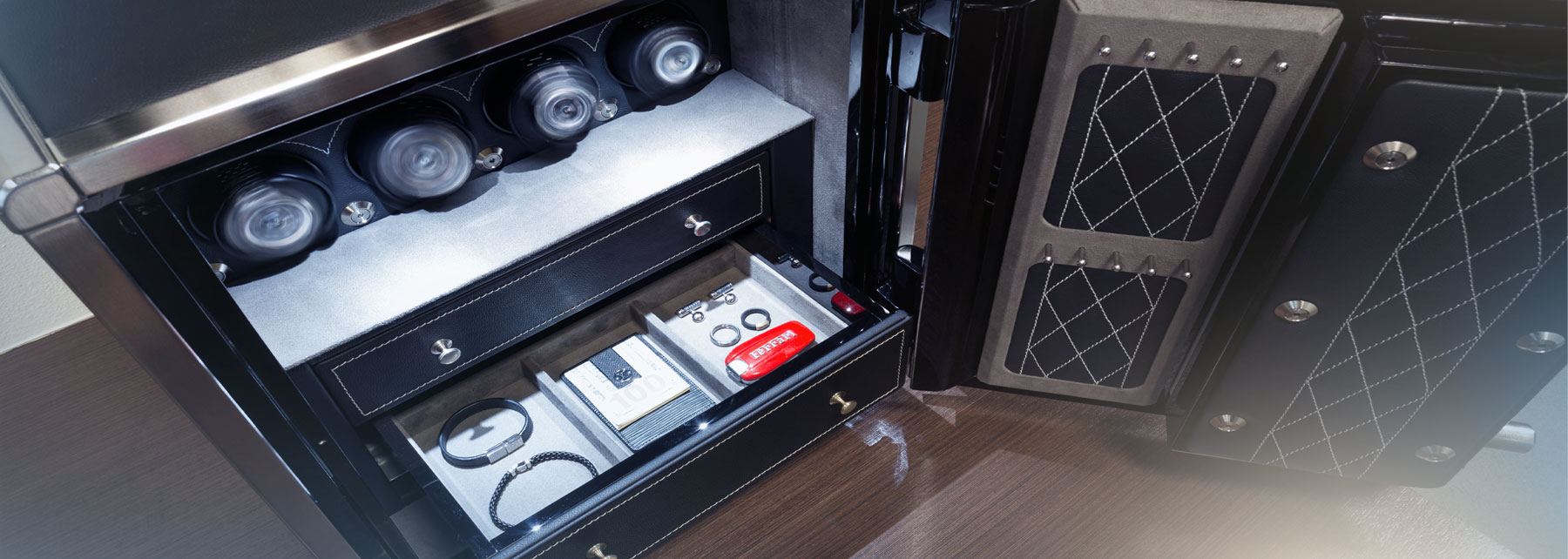 Small jewelry safe with leather exterior designed to protect and store watches and jewelry